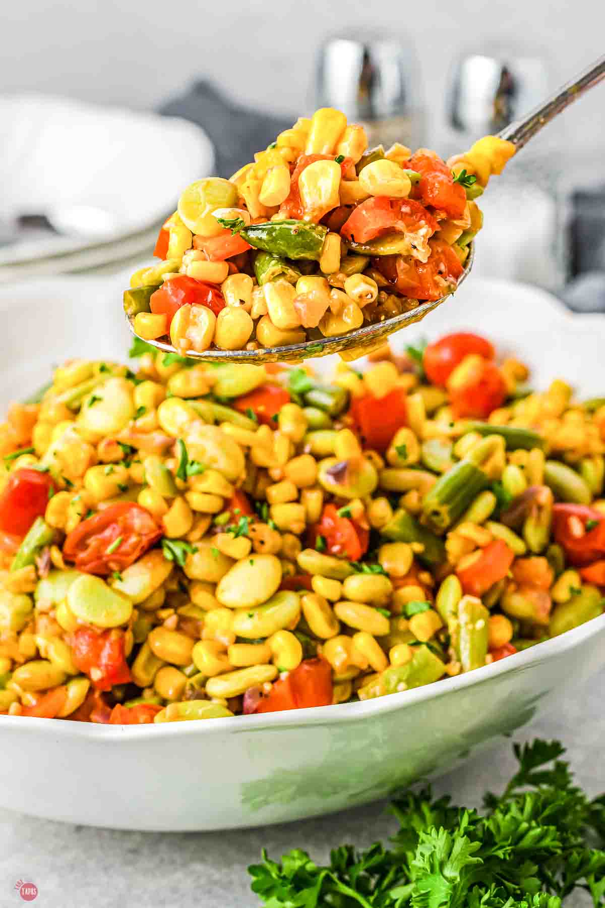 bowl of corn and lima beans with a spoon scooping some out
