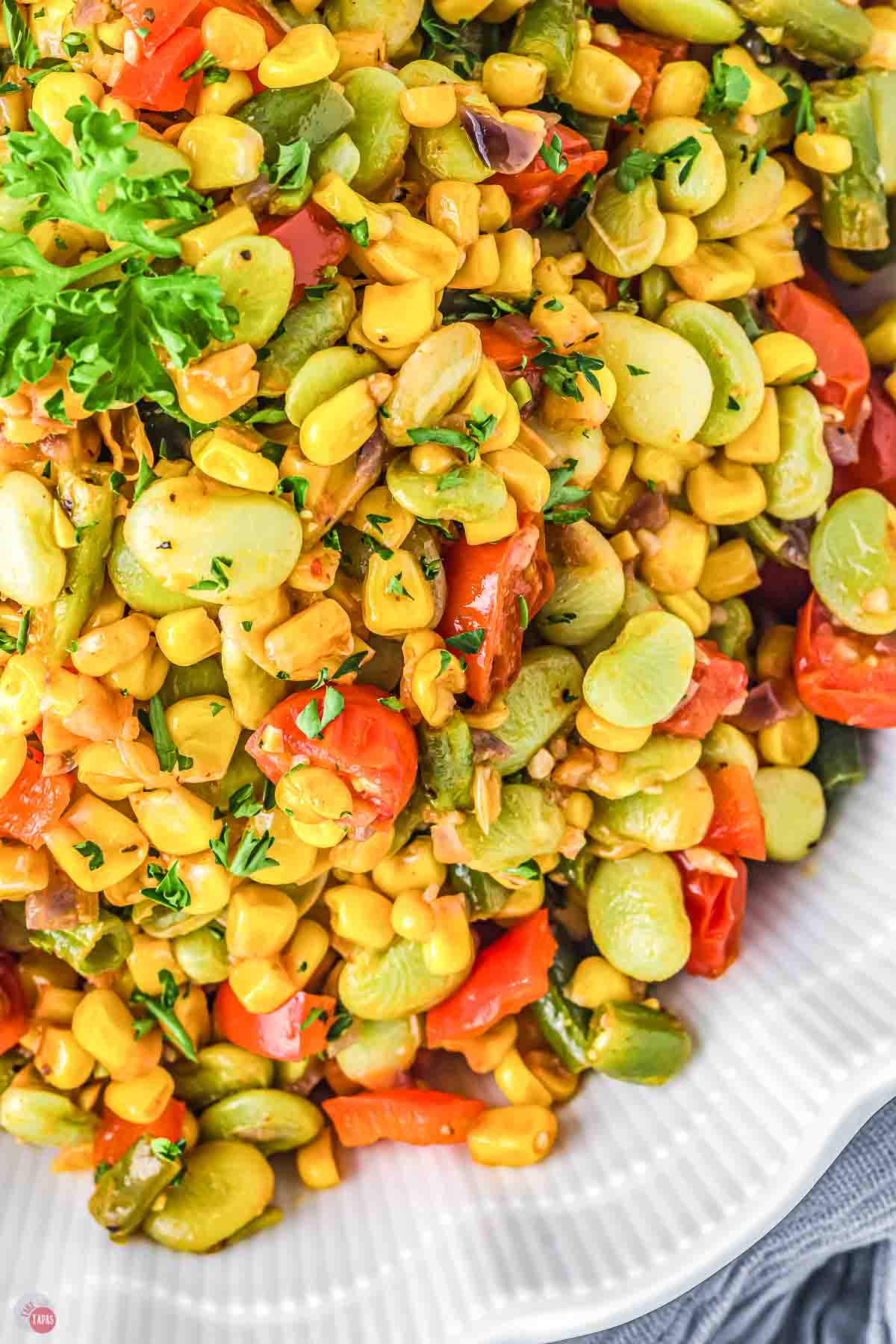 close up of corn succotash in a white bowl