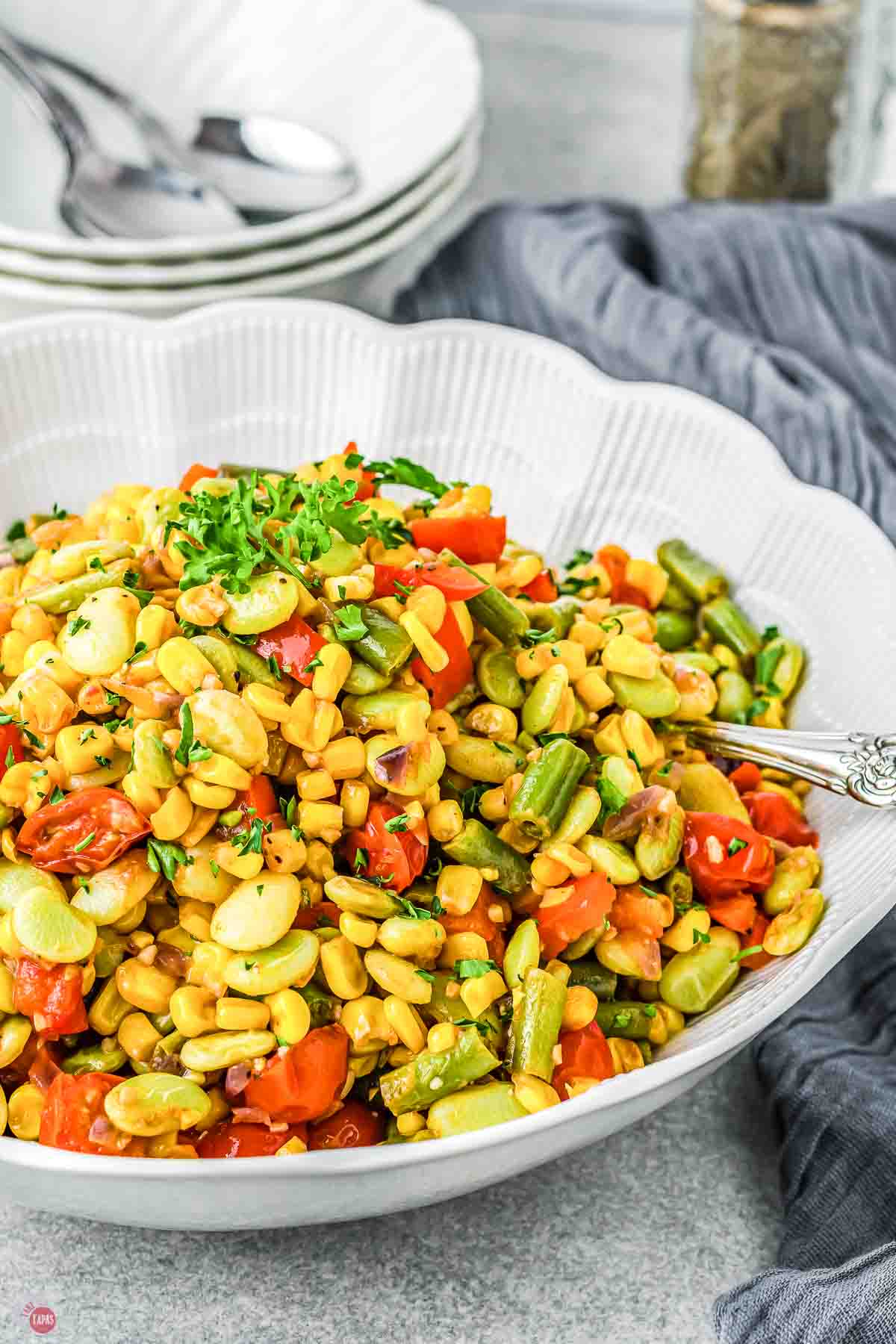 white bowl of vegetables with a spoon