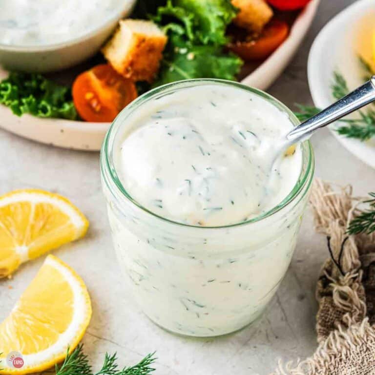 small jar of creamy salad dressing with a spoon in it