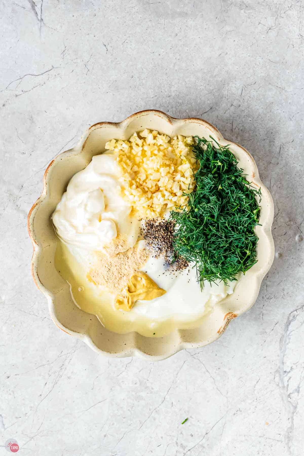 scalloped bowl with unmixed salad dressing ingredients