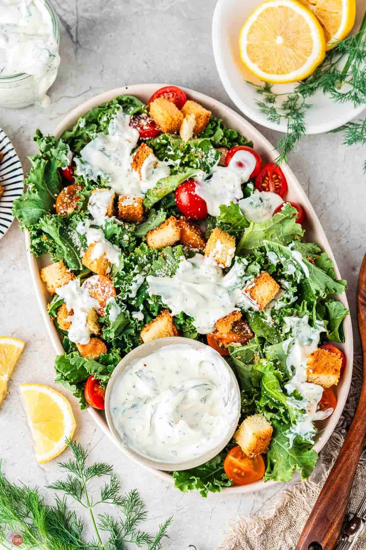 large platter of salad with dressing on it