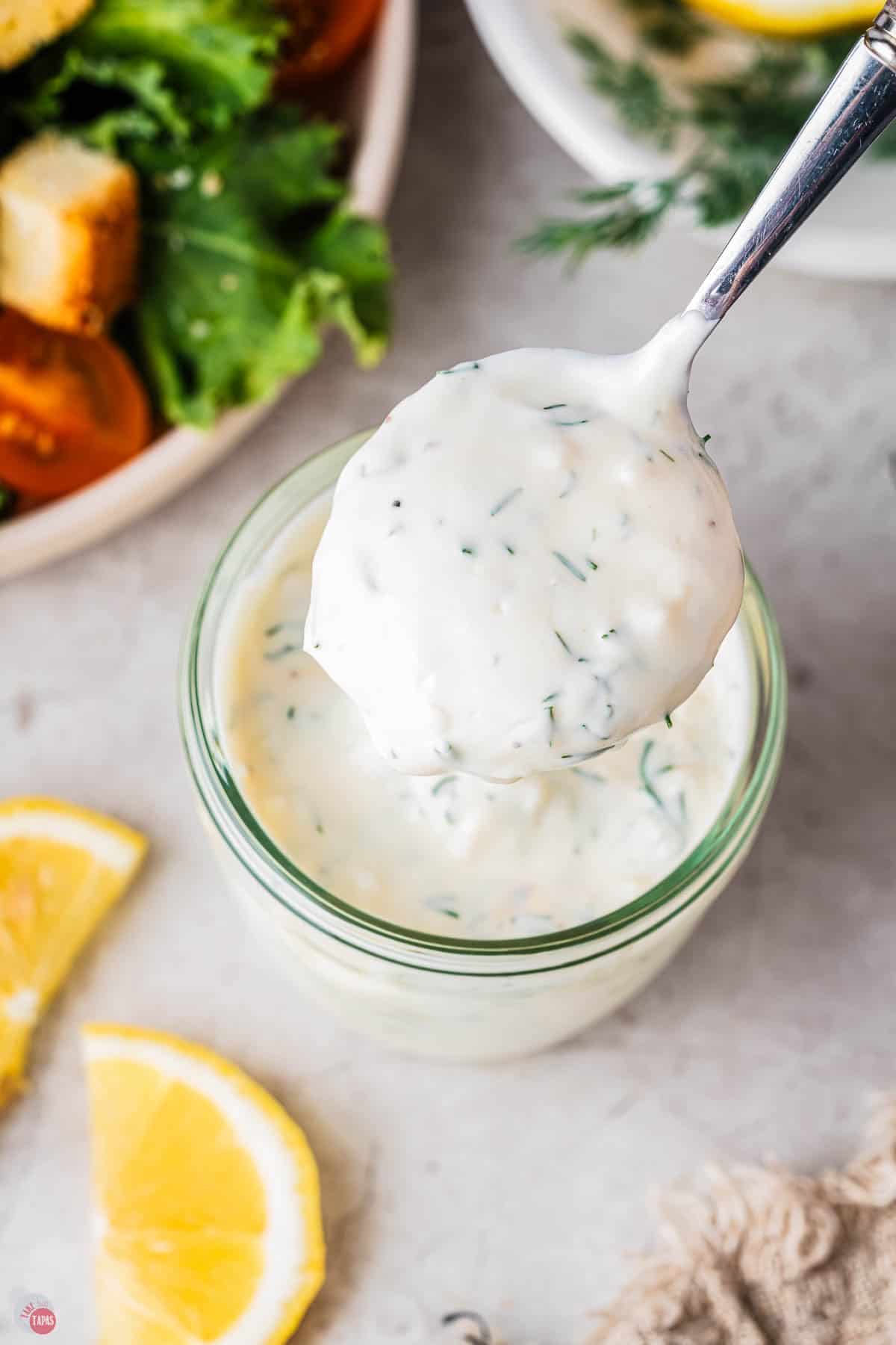spoon scooping out some salad dressing