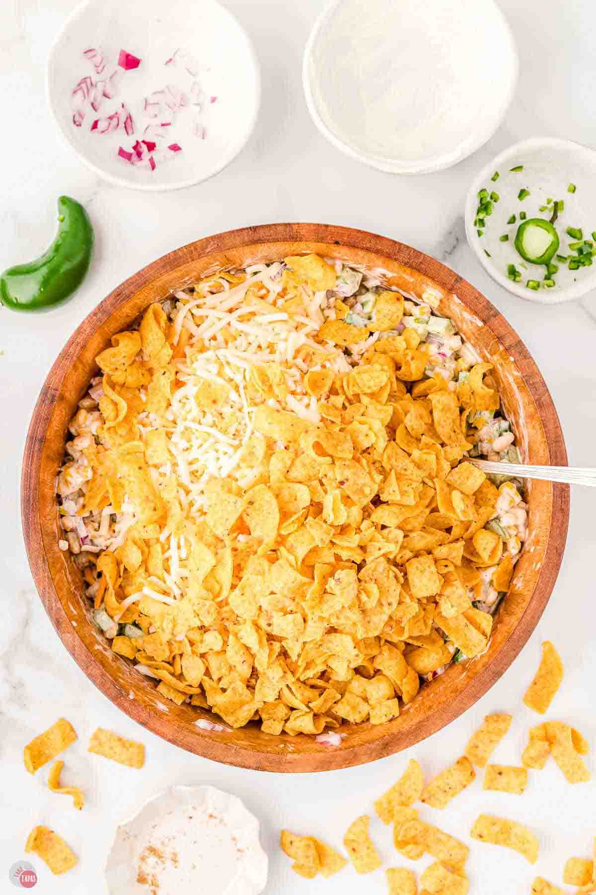 woos bowl full of shredded cheese and corn chips