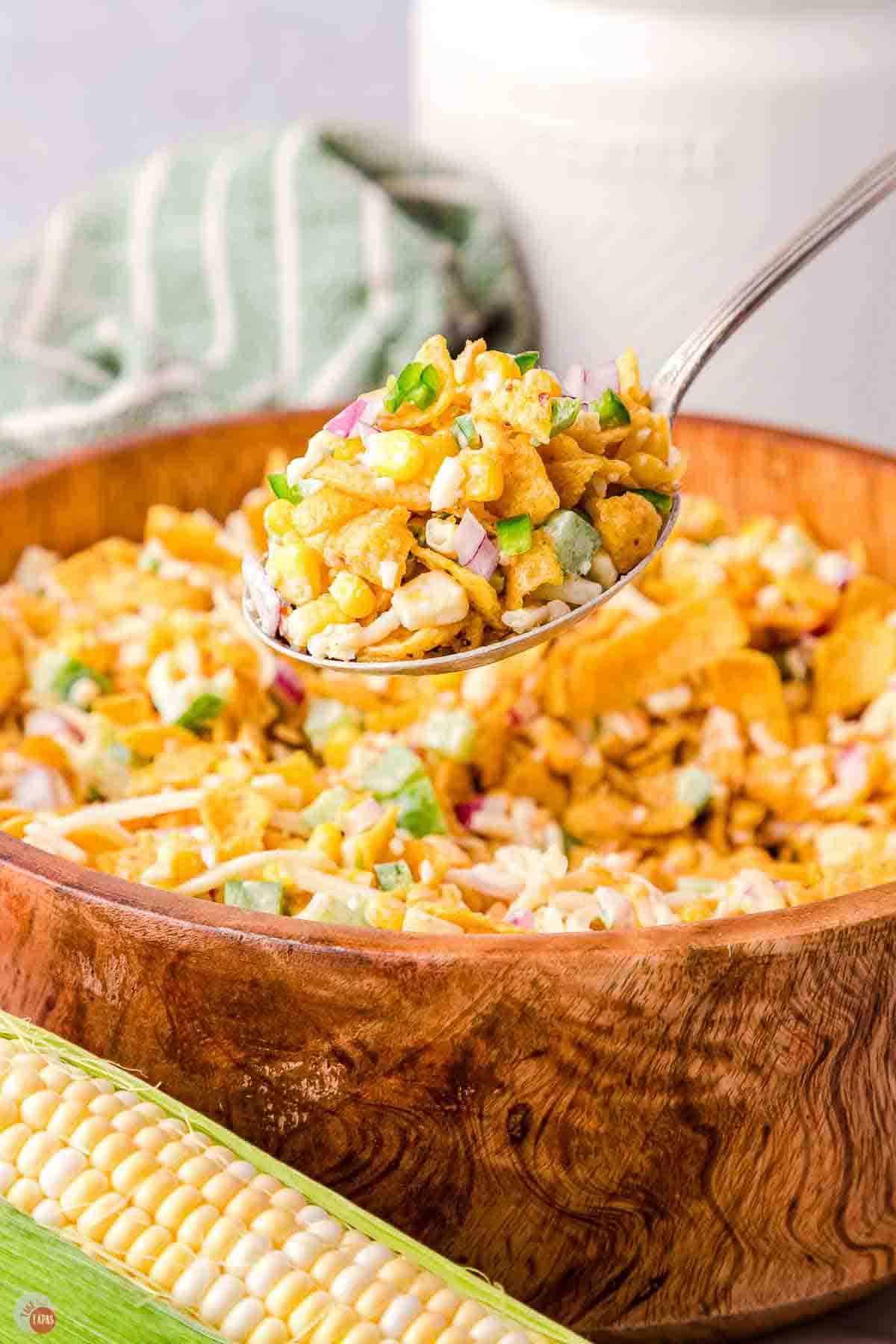 close up of spoon with corn chip salad