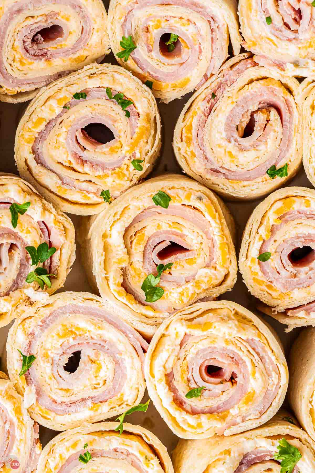 close up of ham and cheese tortilla rolls
