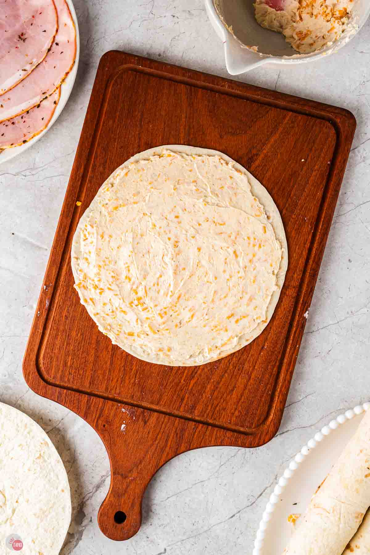 tortilla with cream cheese spread on it
