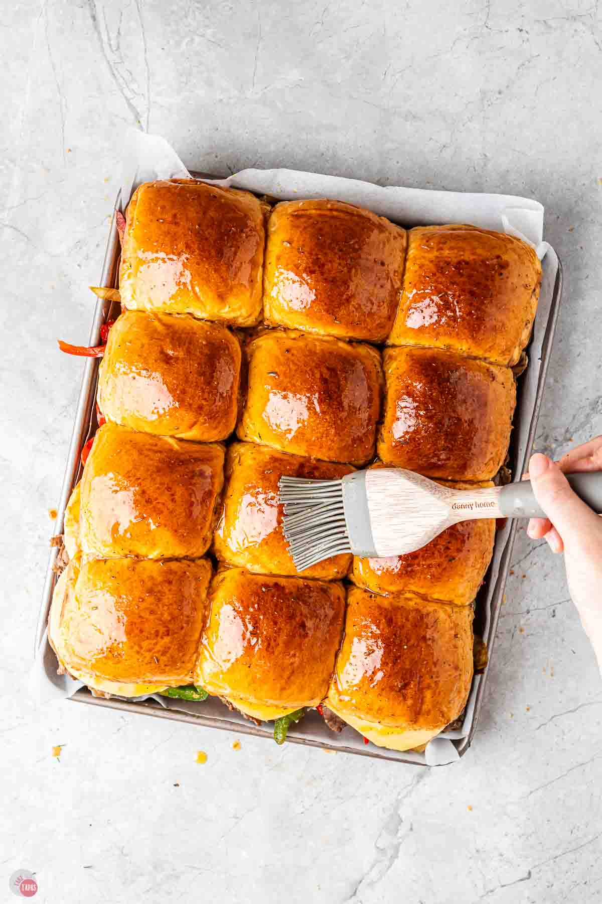 slider buns being brushed with melted butter