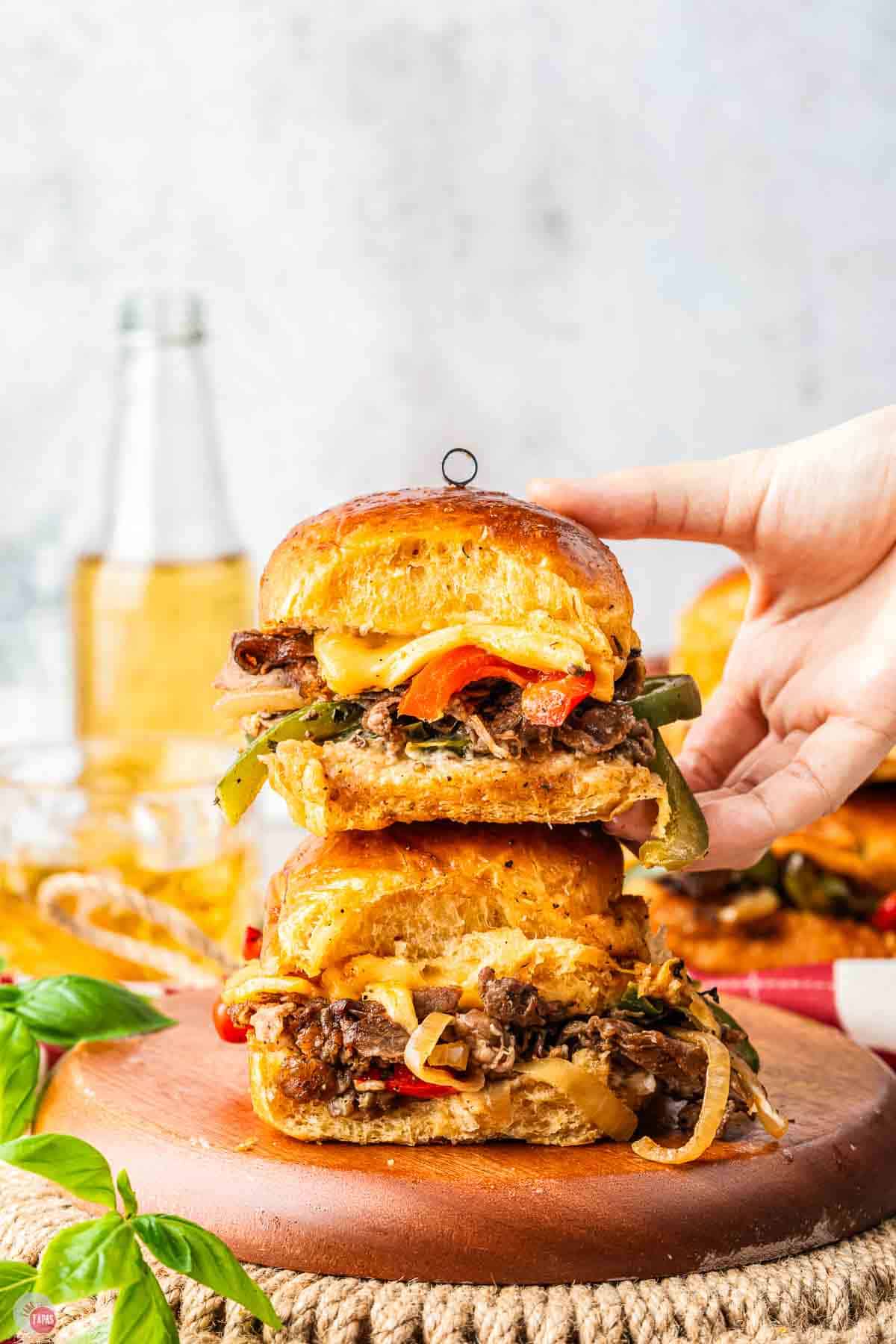 stack of sliders with a hand grabbing the top one