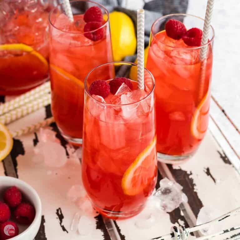 three glasses of raspberry iced tea on a white tray