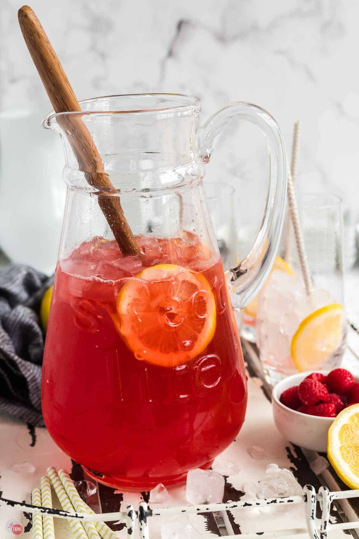 tea pitcher with pink tea and lemon slices