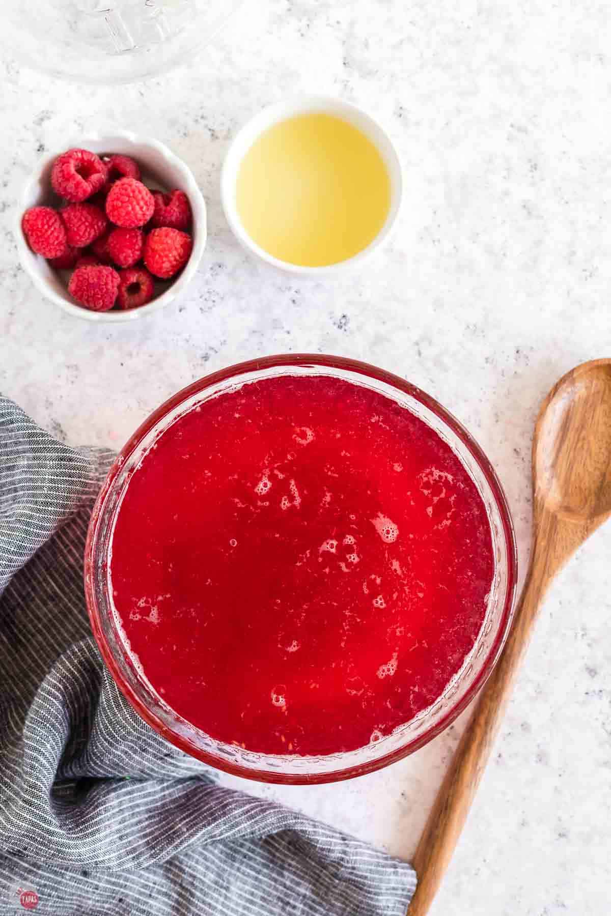 raspberry syrup strained into a clear bowl