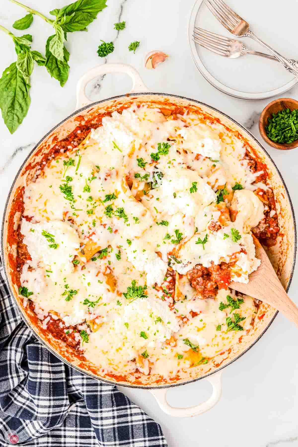 skillet lasagna topped with cheese and chopped parsley