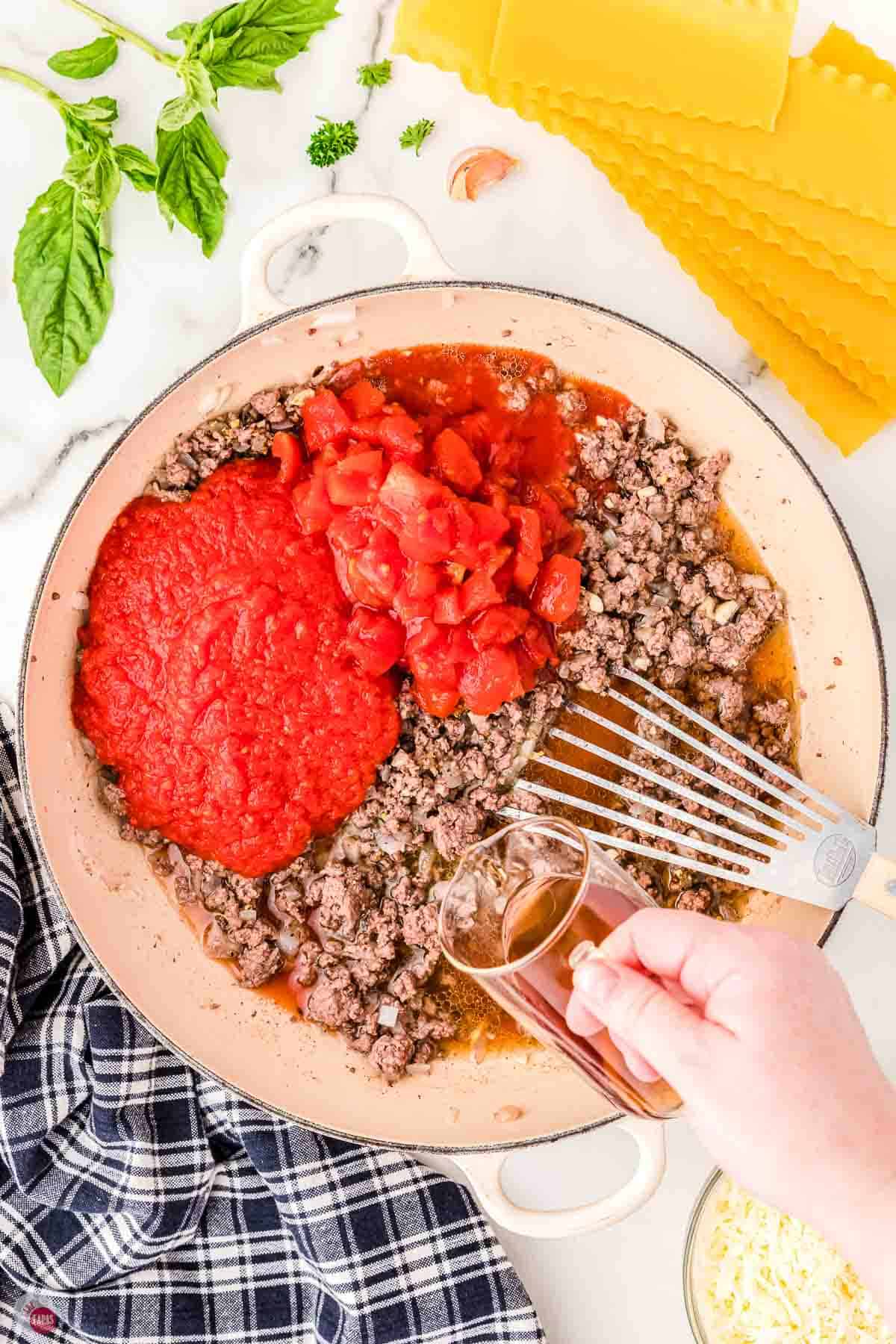 ground beef and tomato sauce simmering in a skillet