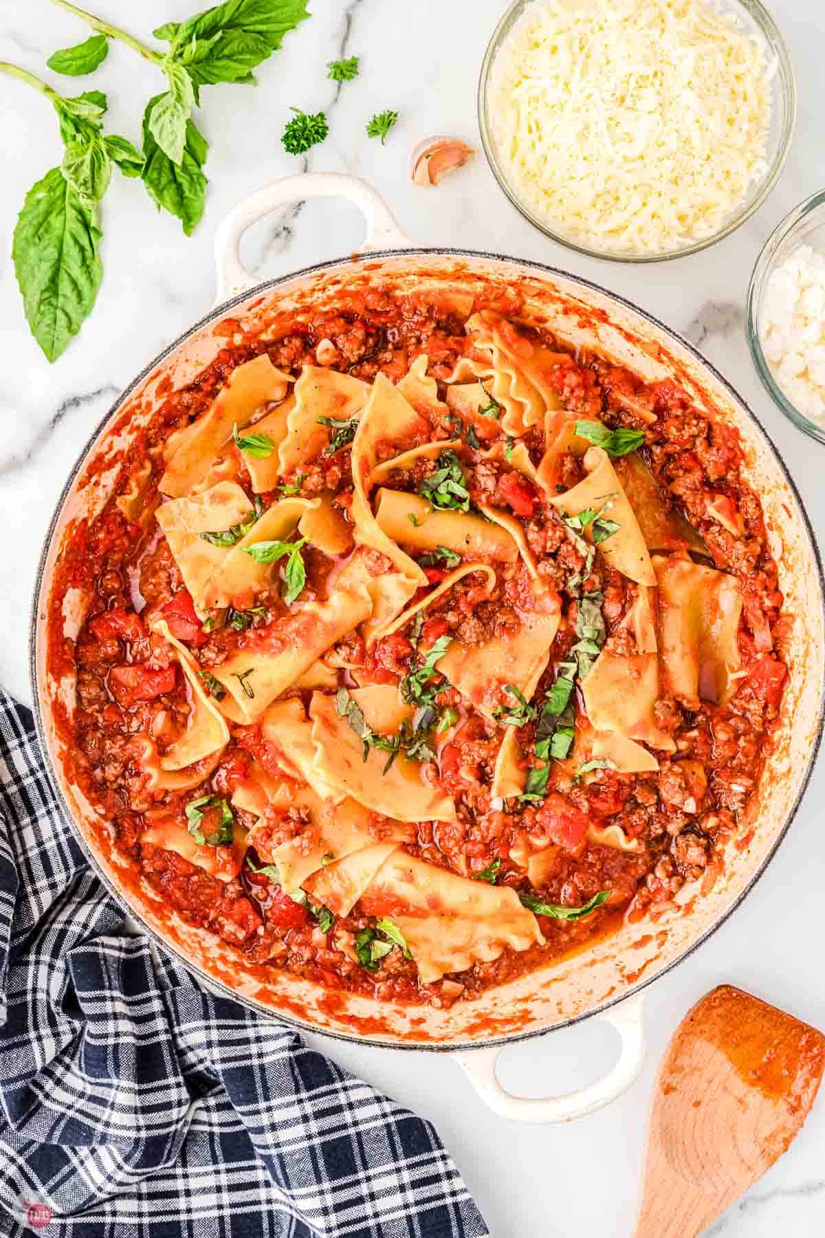 pan with meat sauce and lasagna noodles in it