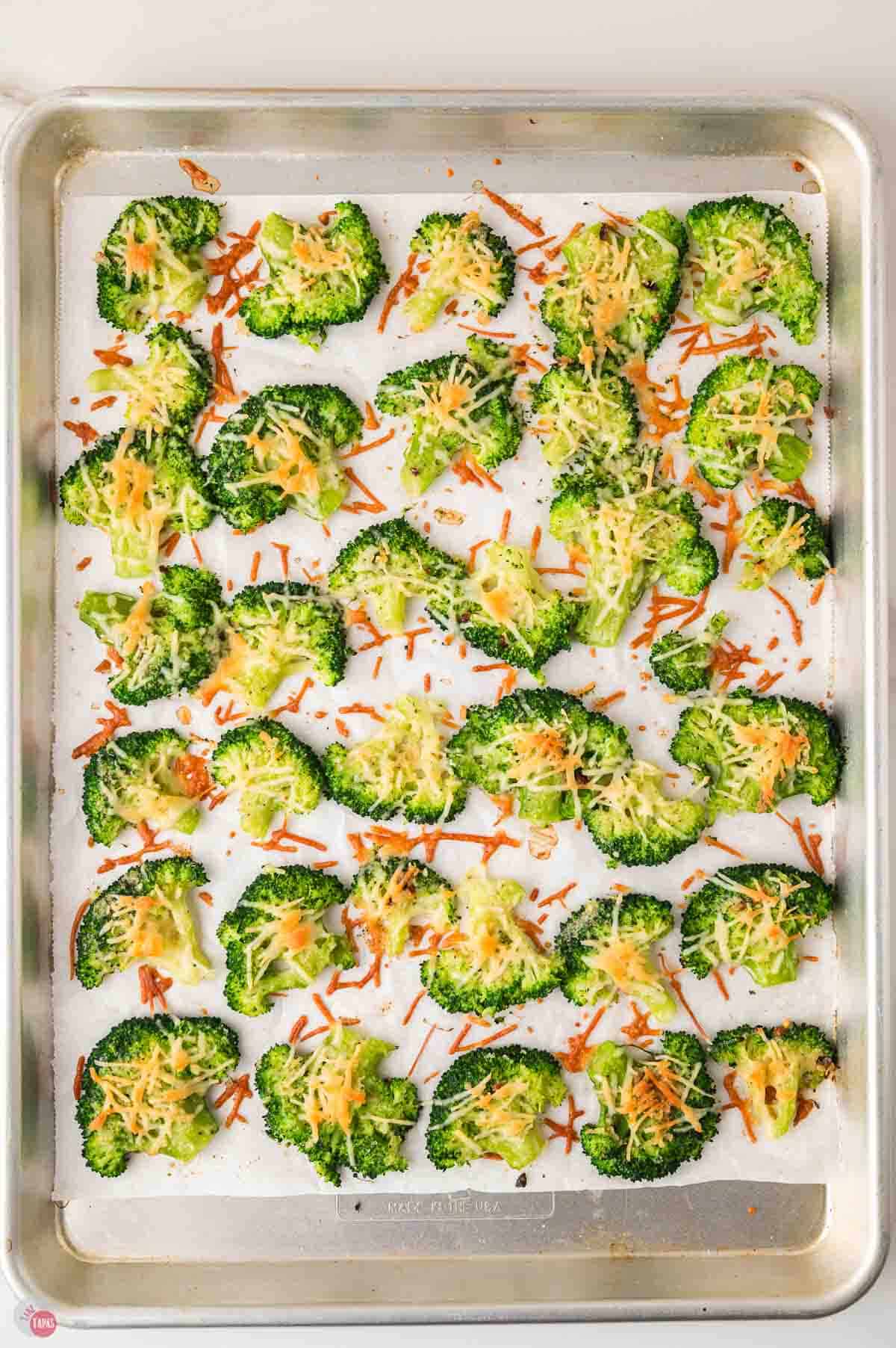 parchment lined baking sheet with smashed broccoli