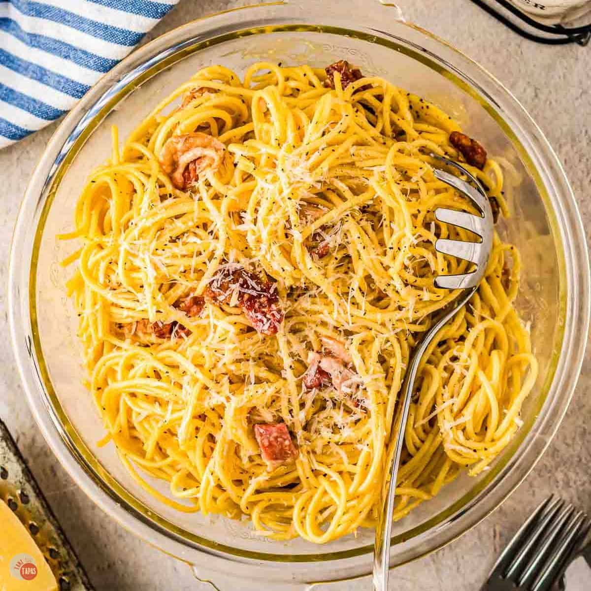 bowl of spaghetti with cheese and bacon