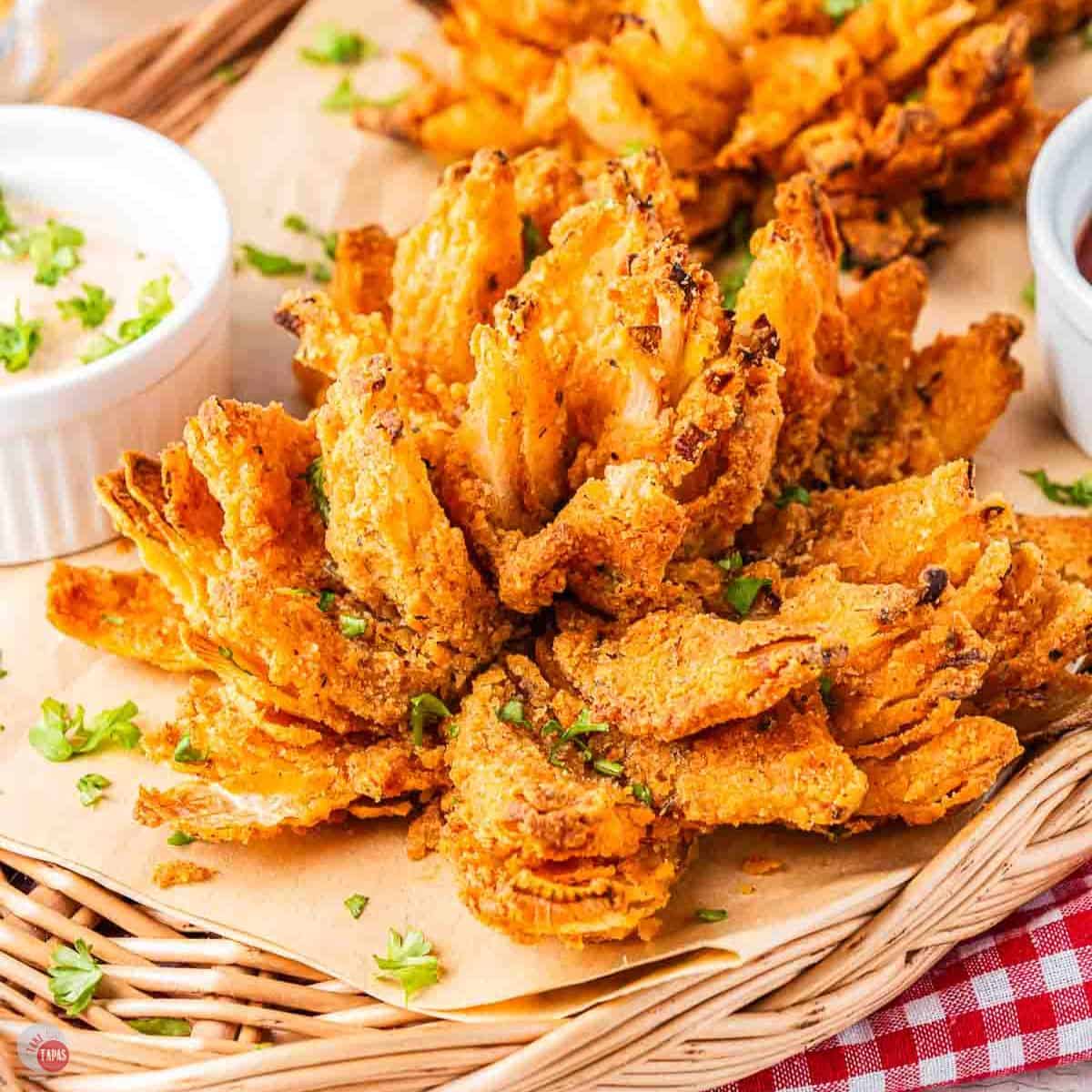 air fryer blooming onion on a piece of parchment paper