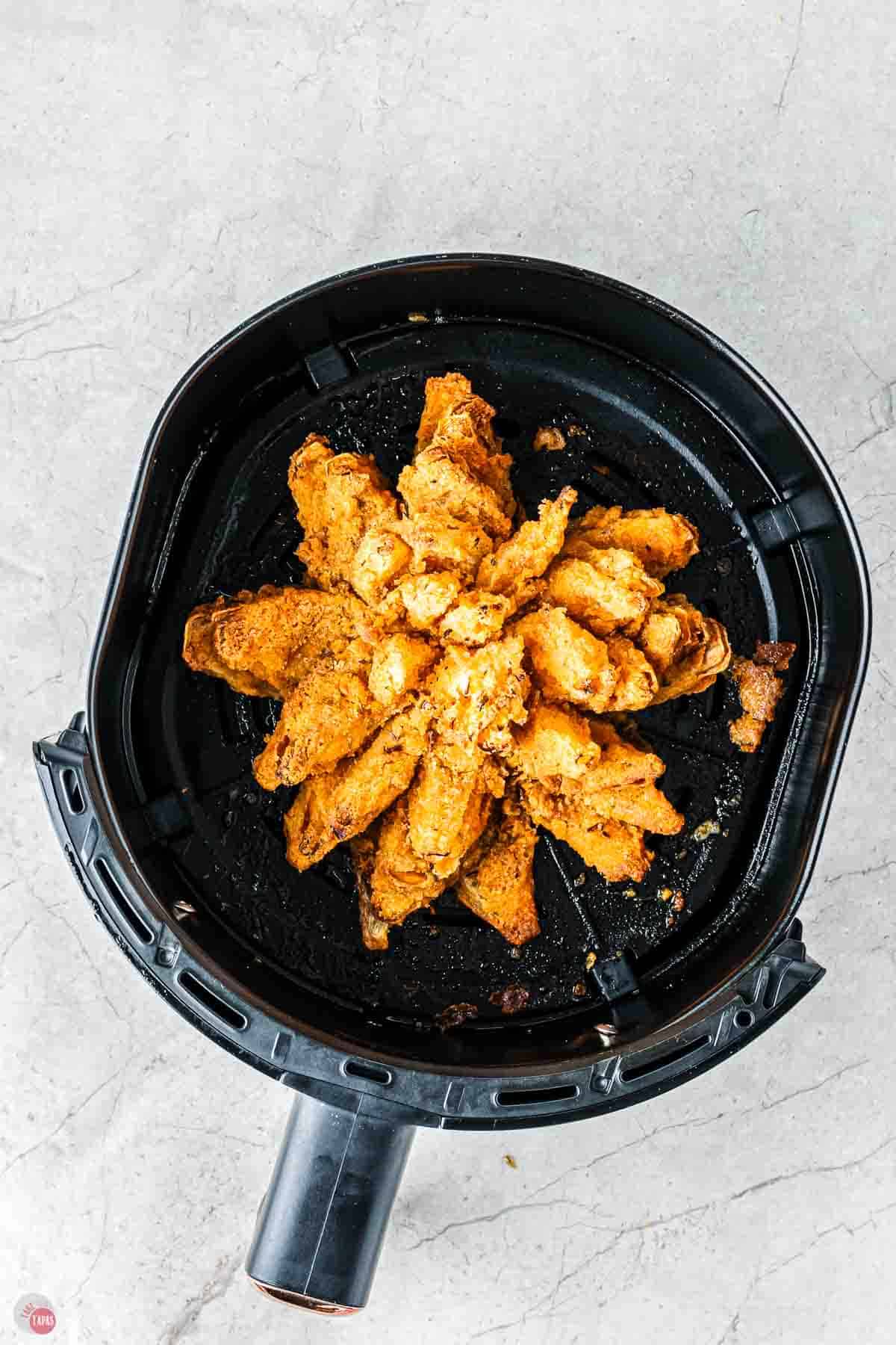 blooming onion in an air fryer basket