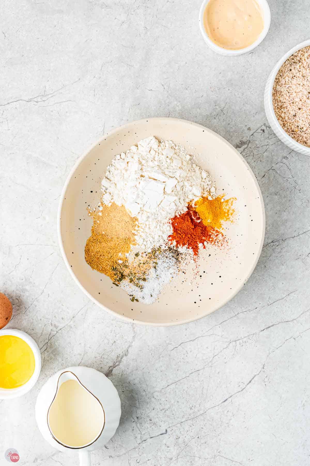 spices and flour in a bowl to make a coating