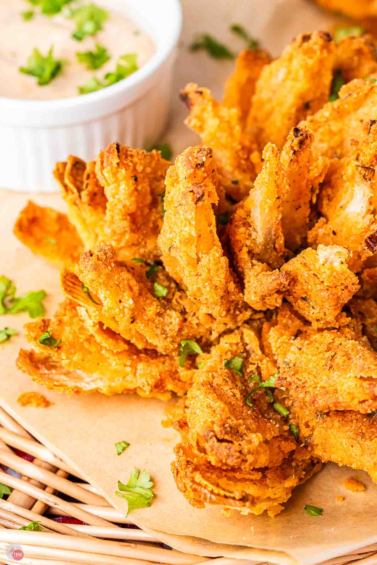 close up of air fryer blooming onion on a piece of parchment