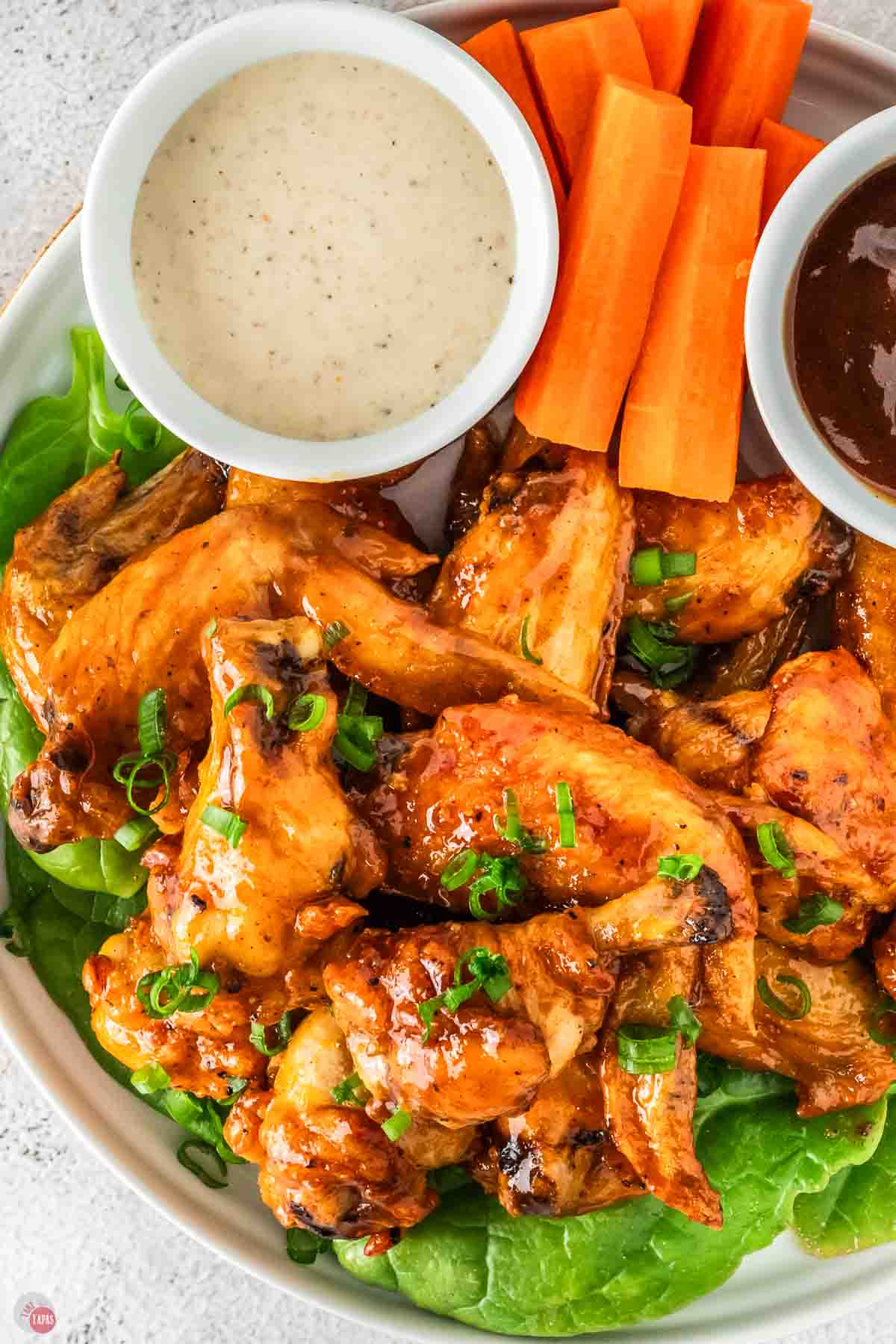plate of crispy buffalo wings that have been cooked in the air fryer.
