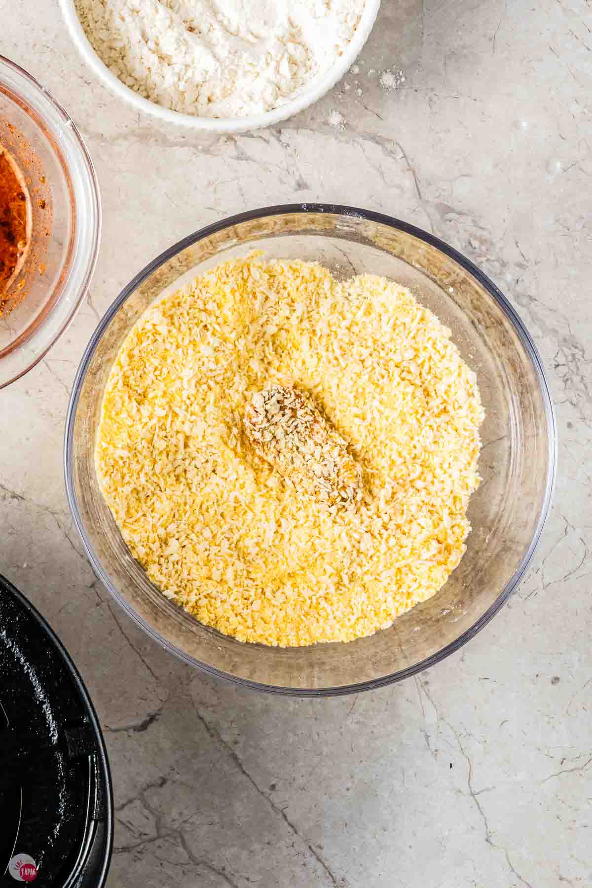 pickles slice being coated in cornmeal
