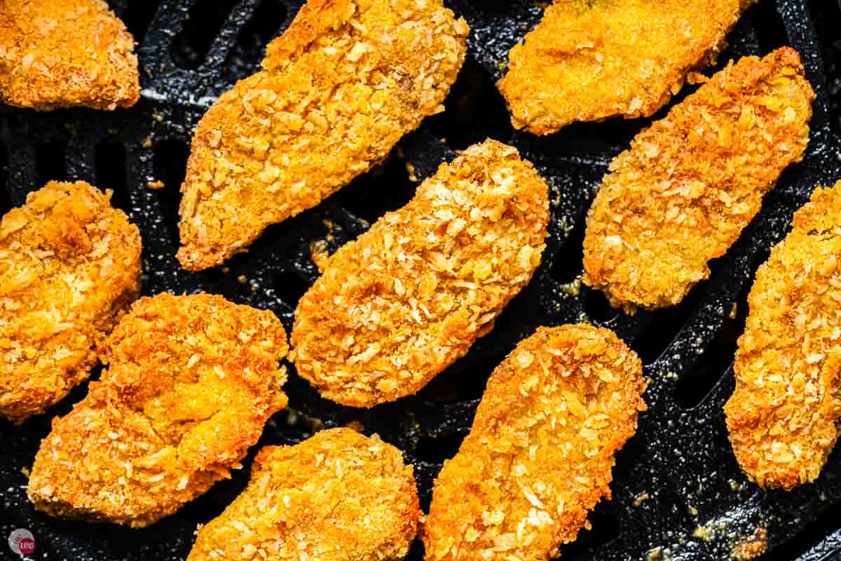 close up of fried pickles on a black basket