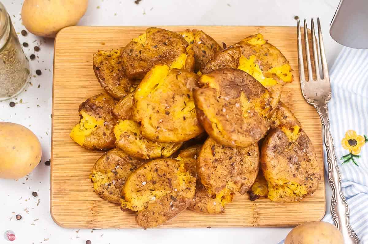board covered with smashed baby potatoes