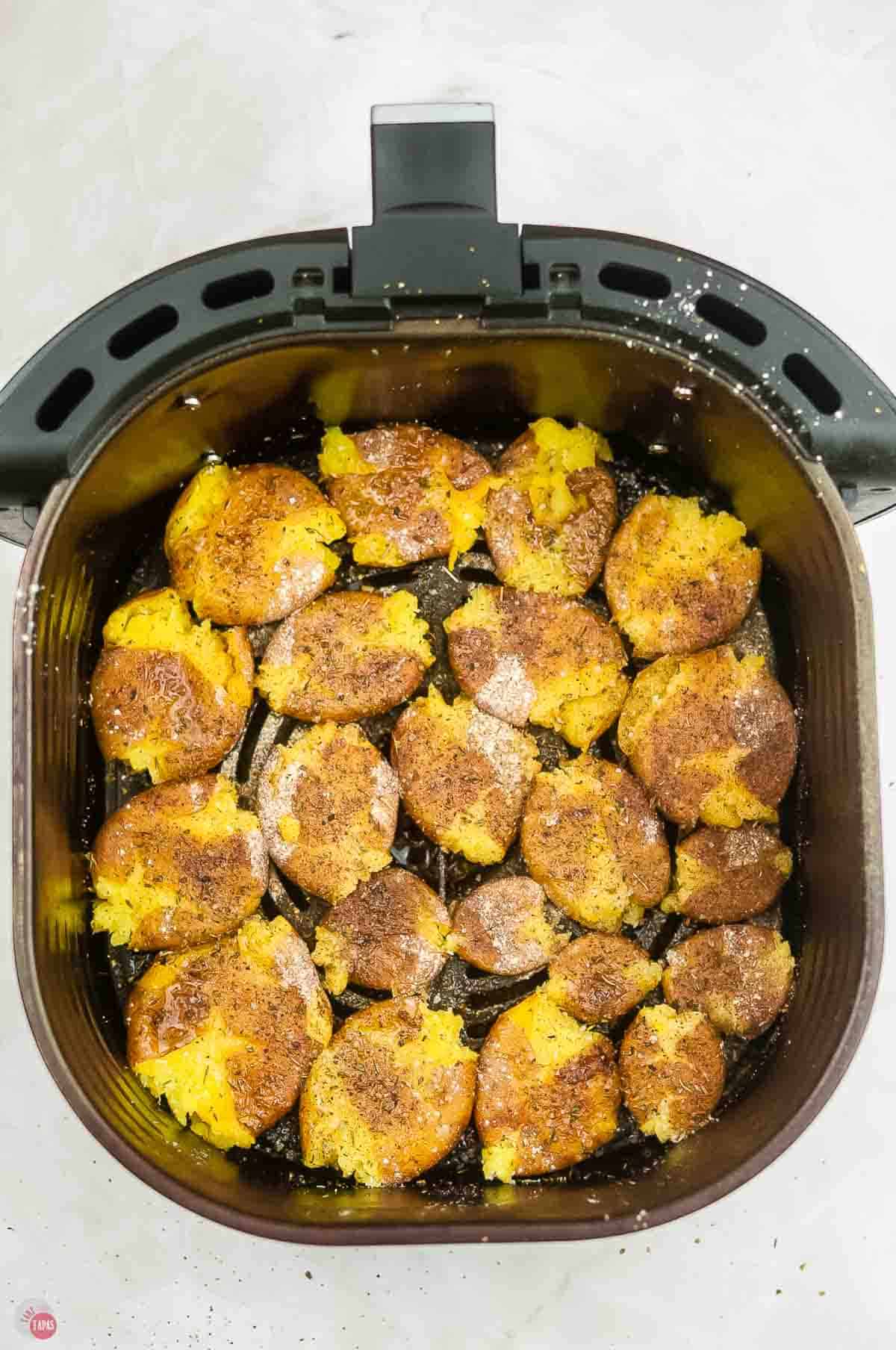 smashed potatoes in an air fryer basket