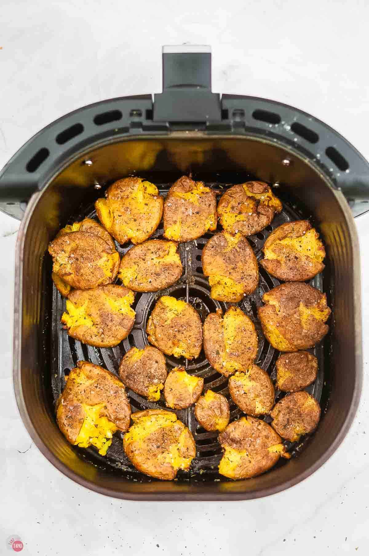 cooked potatoes in an air fryer basket