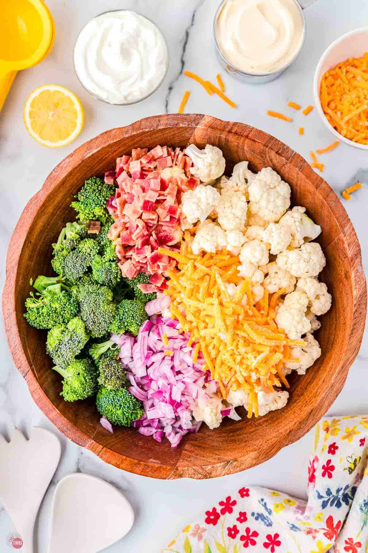 chopped vegetables in wood bowl in separate piles