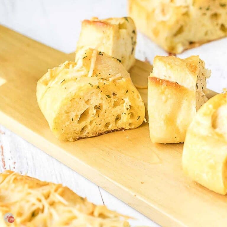 slices of garlic bread on a wood cutting board