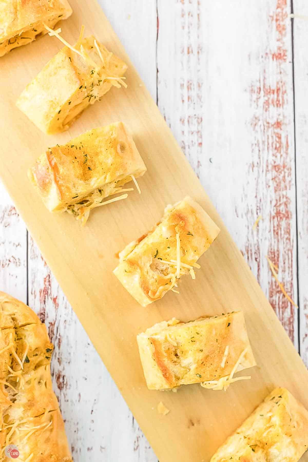 cutting board with slices of cajun seasoned garlic bread