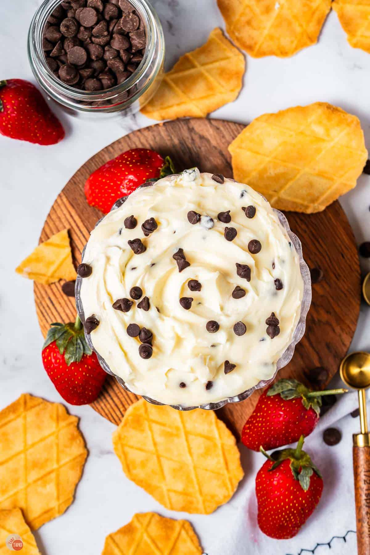 bowl of cannoli dip with waffle cone pieces and fresh strawberries