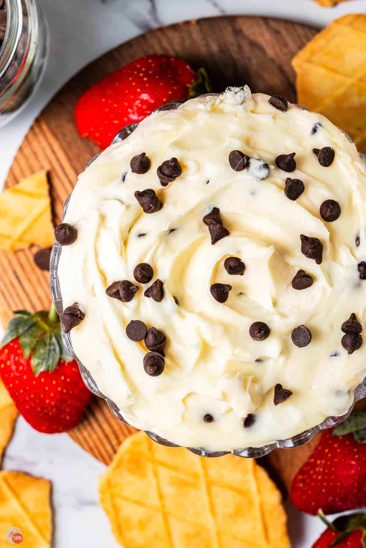 bowl of cannoli dip with strawberries and waffle cone pieces