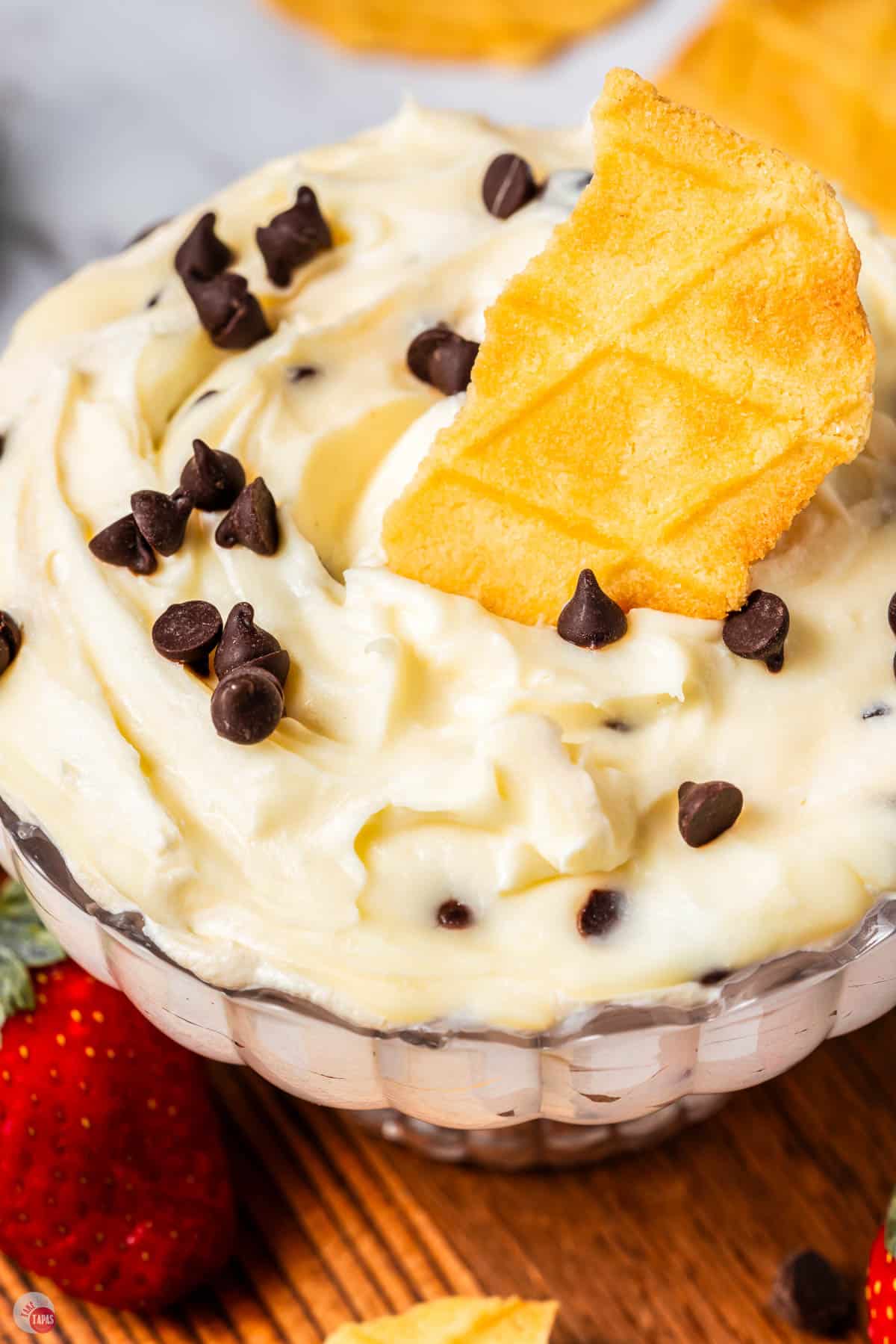 close up of cannoli dip with mini chocolate chips and waffle cone pieces