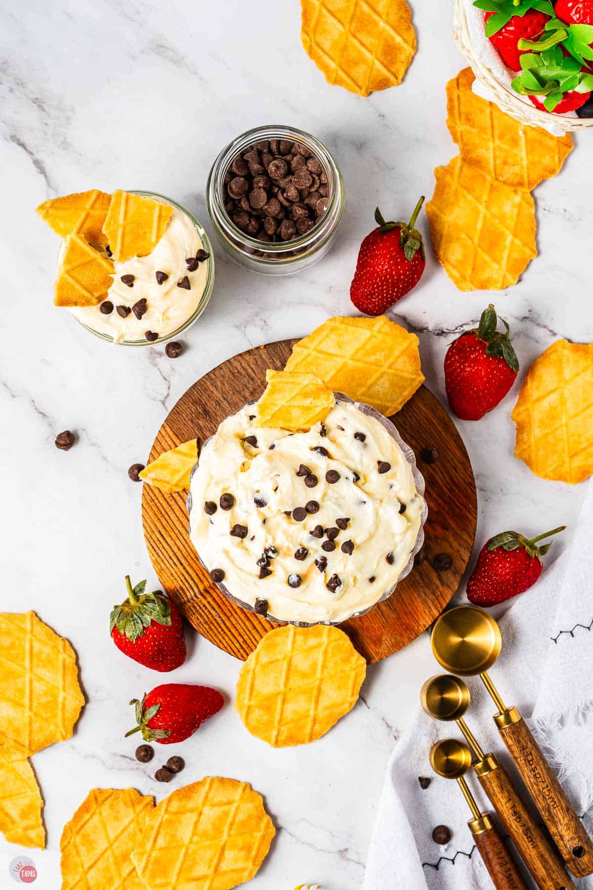 two bowls of cannoli dip with waffles cones and berries