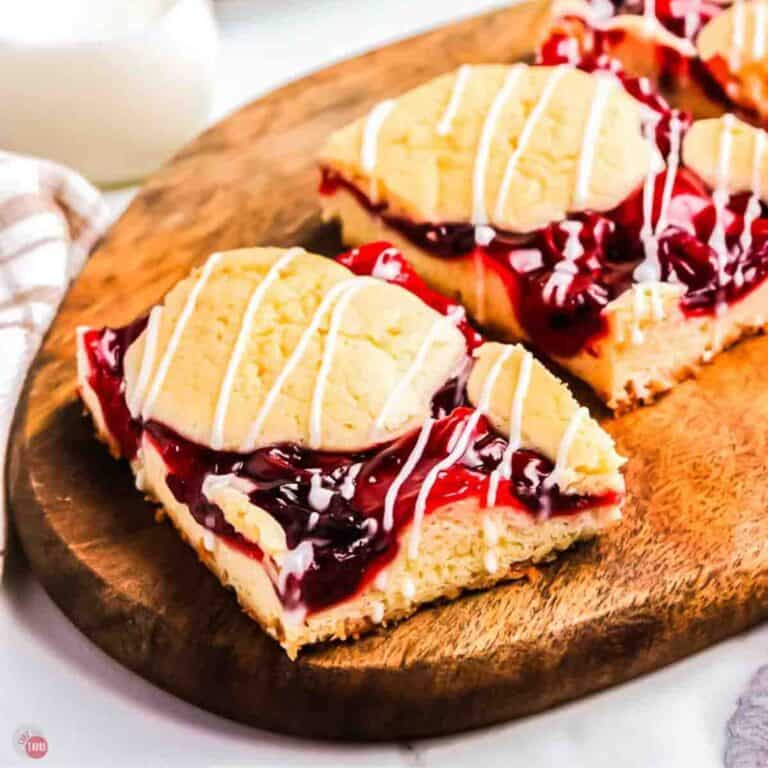 two cherry pie bars on a wood board