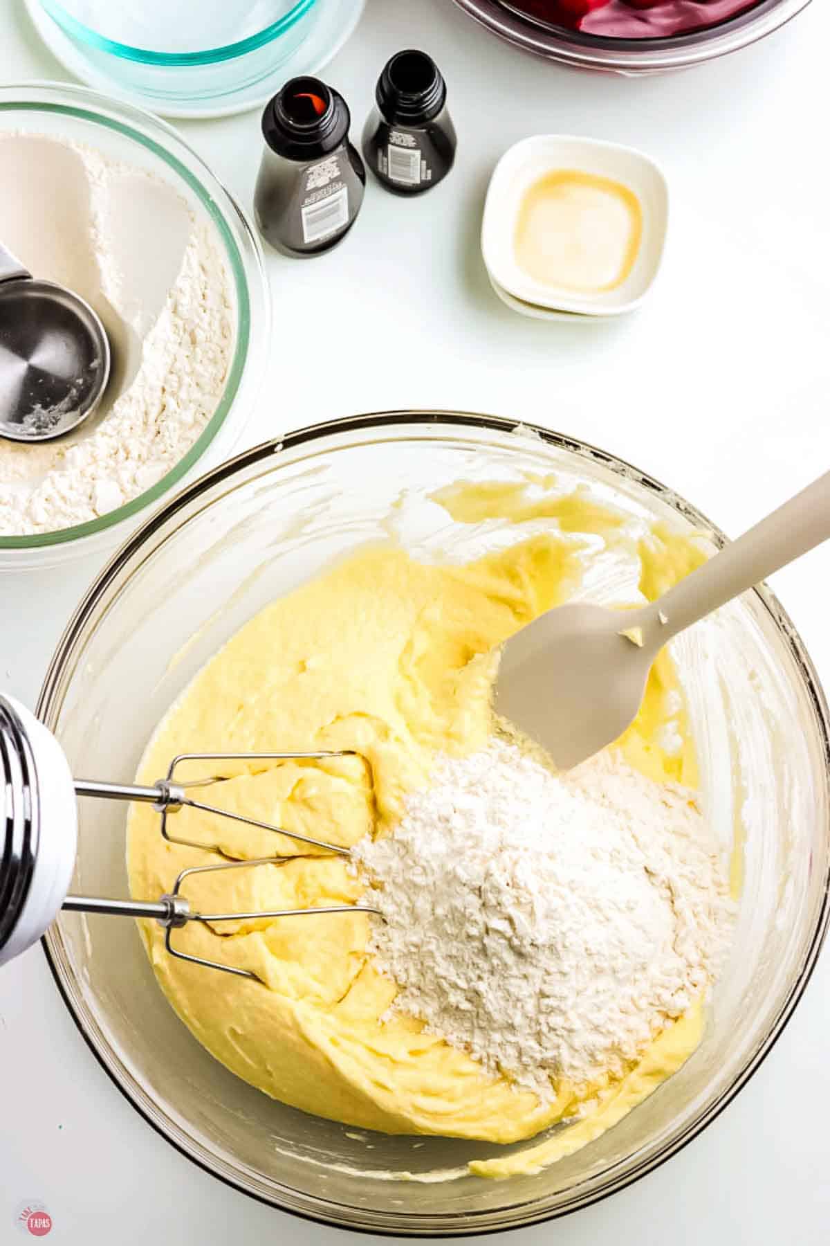 flour and butter being mixed together in a clear bowl