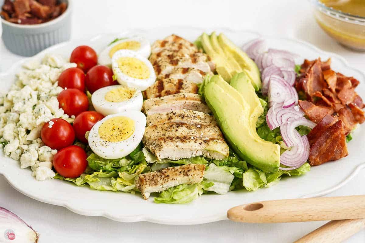 side view of salad on a white platter