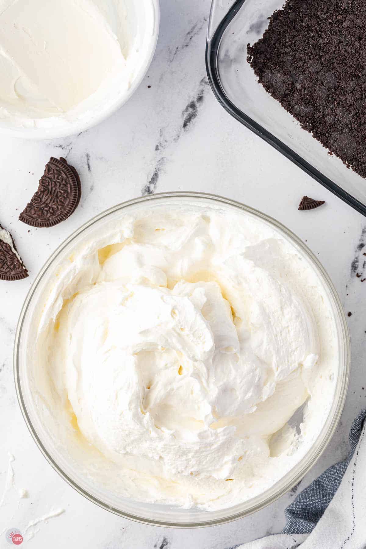 cream cheese and sugar whipped in a clear bowl