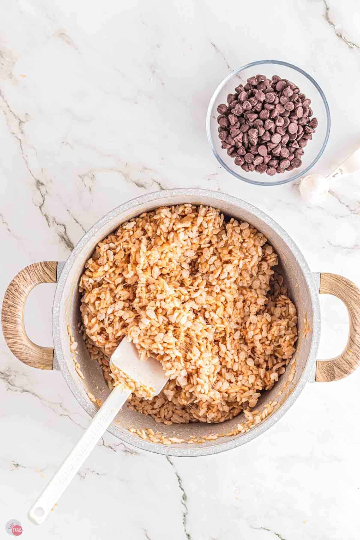 rice krispies being stirred in a pot
