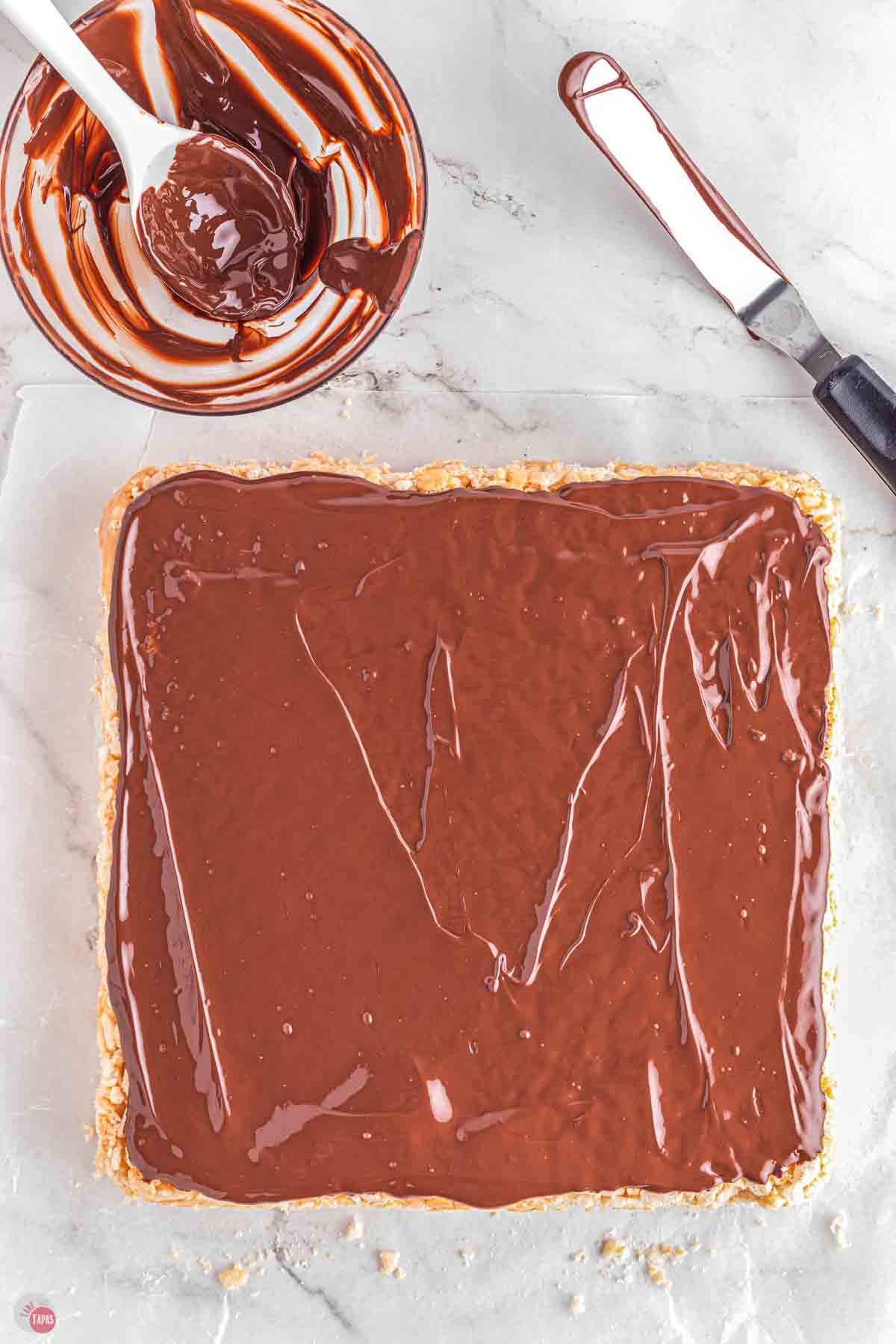 marshmallow treats with melted chocolate spread over the top