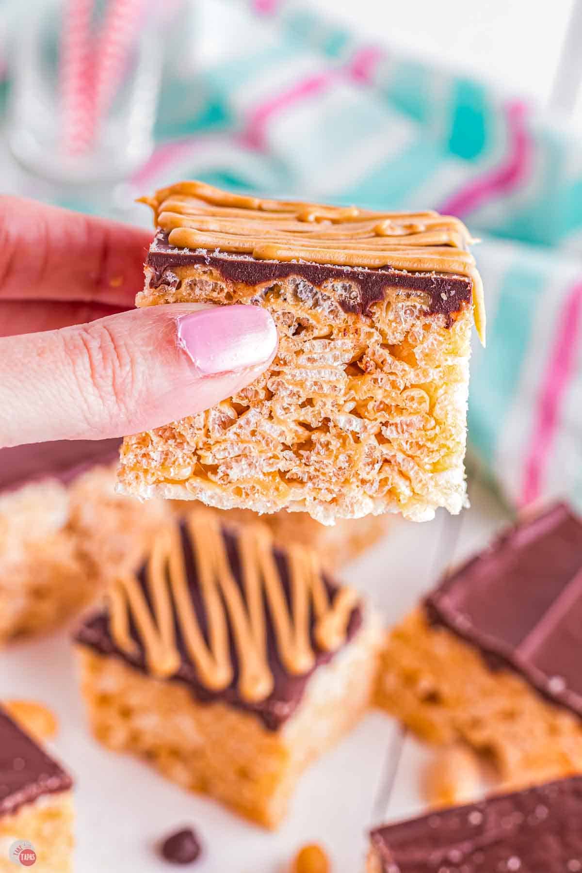 hand holding a chocolate peanut butter marshmallow treat