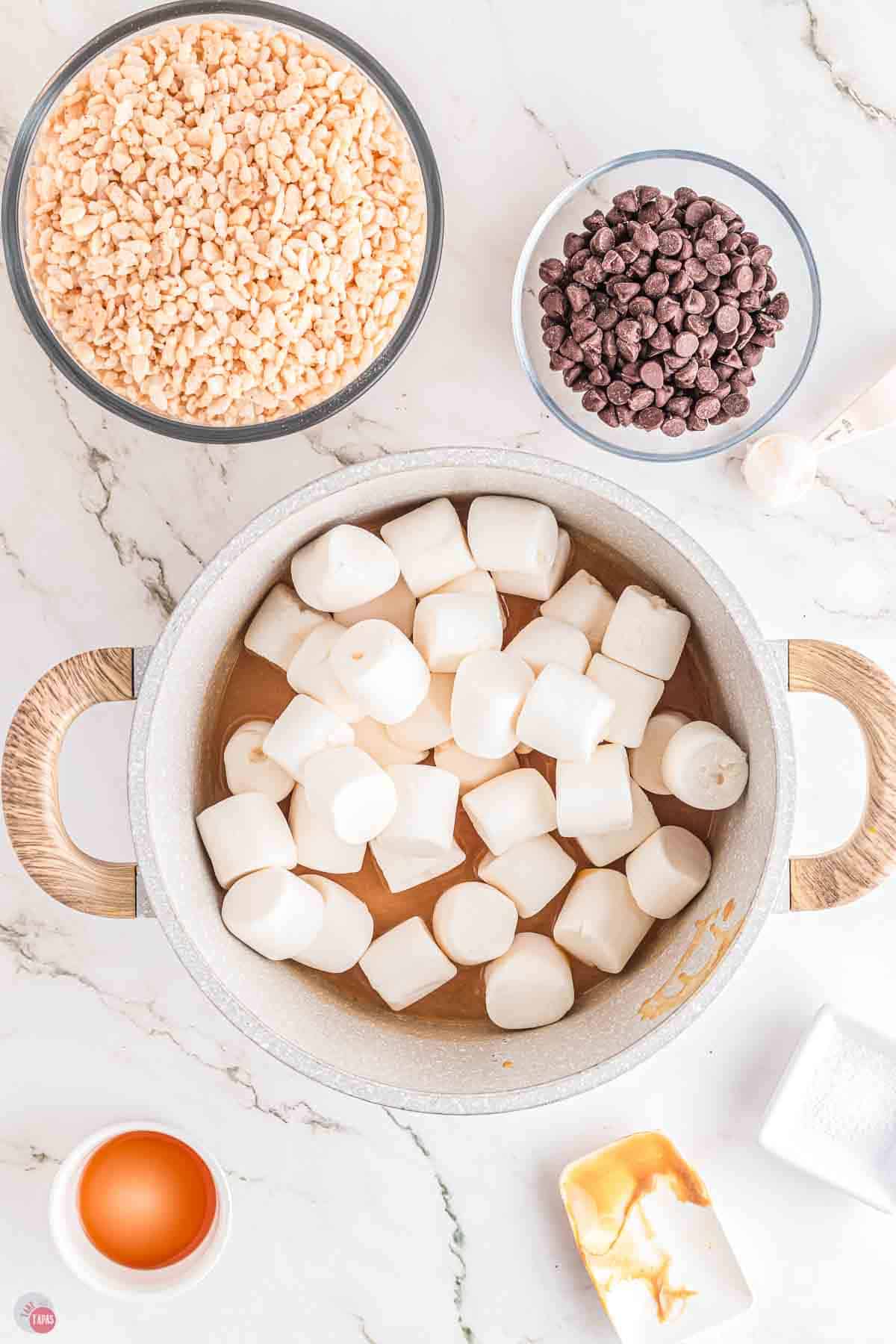 marshmallows in a pot with a bowl of chocolate chips