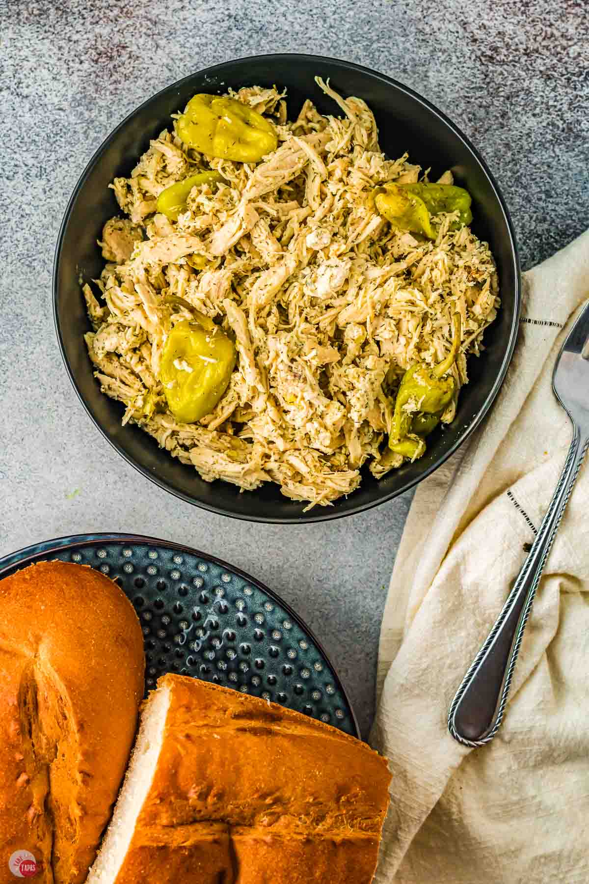 two bowls of chicken with a bowl of sliced bread