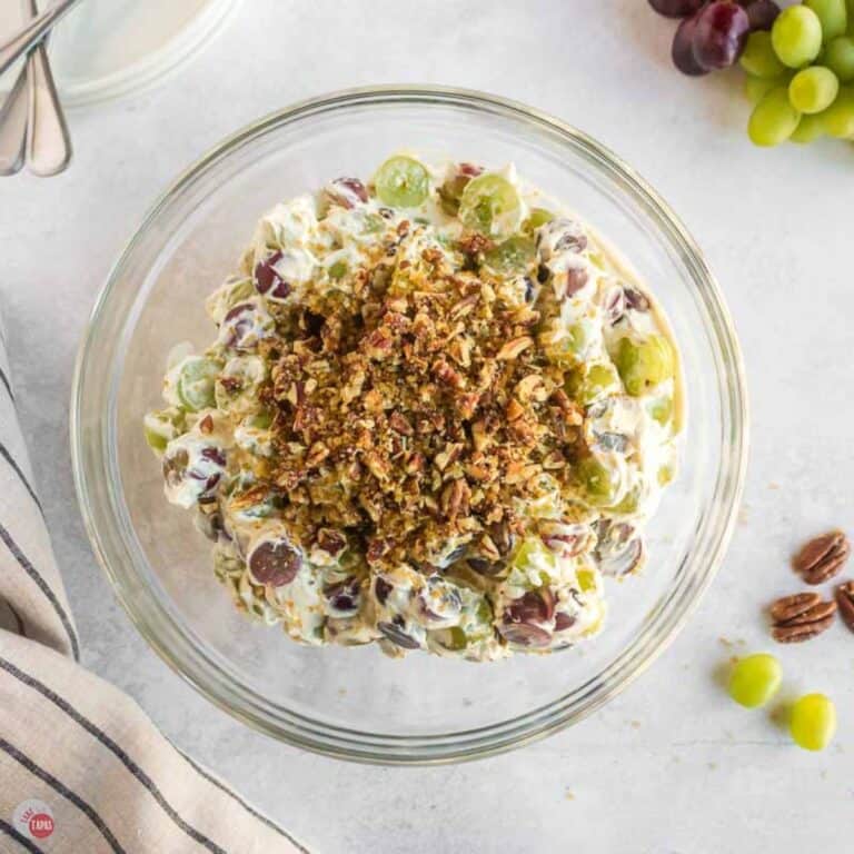bowl of grape salad topped with chopped pecans