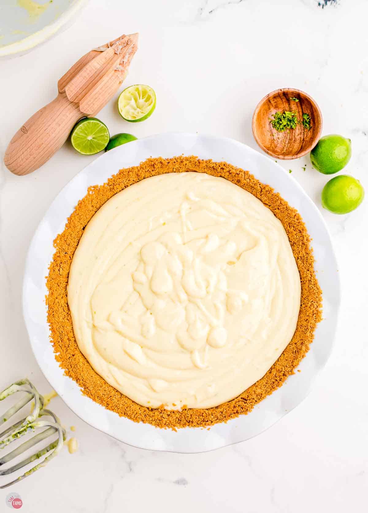 unbaked key lime pie in a white baking dish