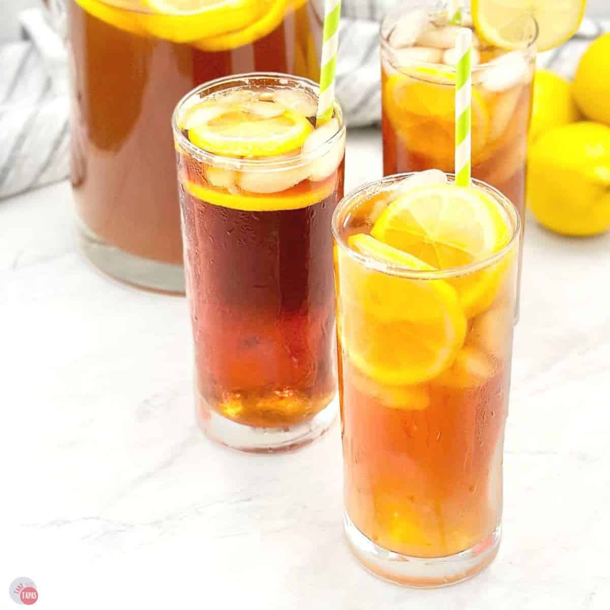 close up of lemon iced tea in tall glasses with straws